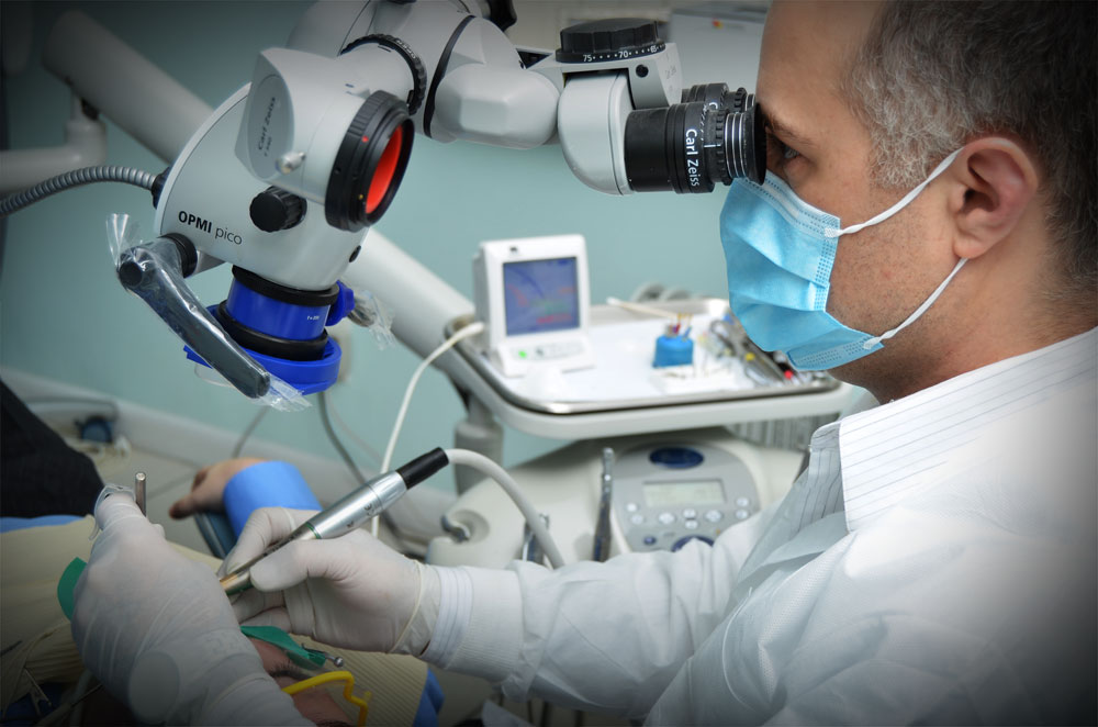 Dr. Mattew Malek treating a patient with Zeiss surgical microscope for dentistry